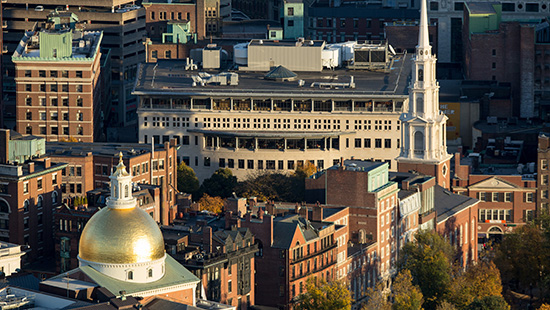 A birds eye view of Boston, showing the Massachusetts State House, Park Street Church, Suffolk University and more.
