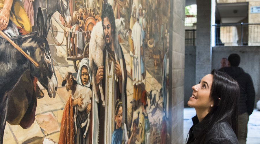 A Suffolk student looks up at a piece of art in a museum in Israel.