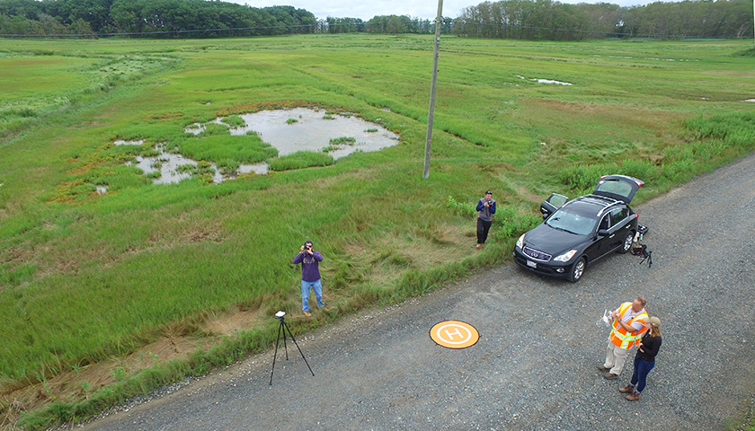 Research team on the ground looks tiny in photo shot from drone
