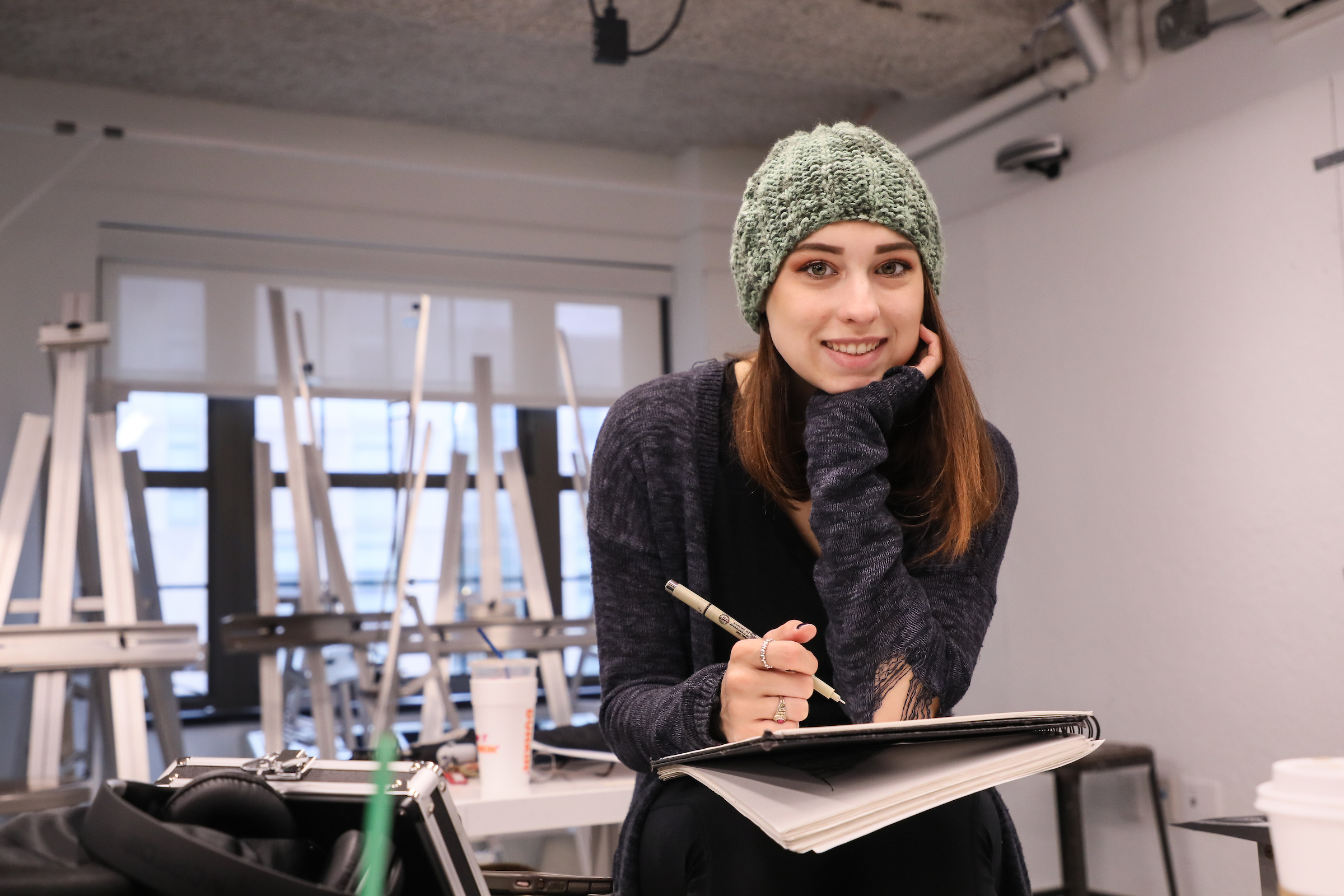 A student poses during a drawing class at the Sawyer Building.