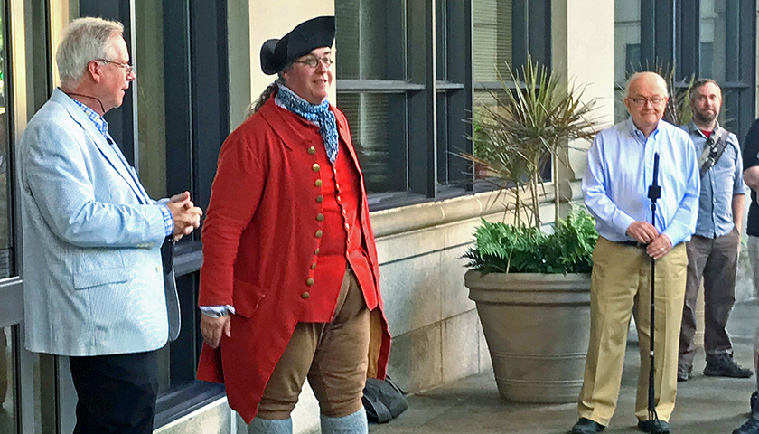 Professor Robert Allison and Walter Johnson, both in modern-day clothing, with a Colonial-era reenactor in front of Sargent Hall. Photo by Lisa Celovsky