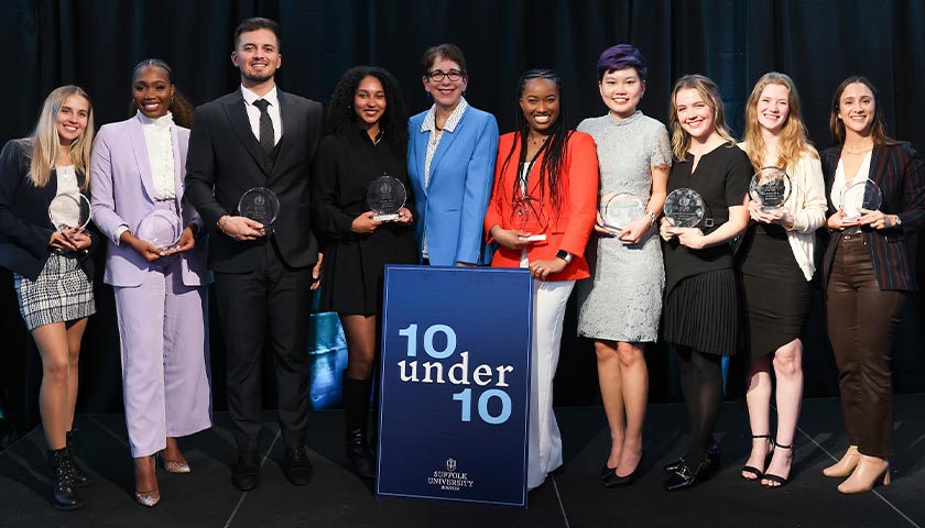 The nine 10 Under 10 honorees who attended the April ceremony pose with Suffolk University President Marisa Kelly