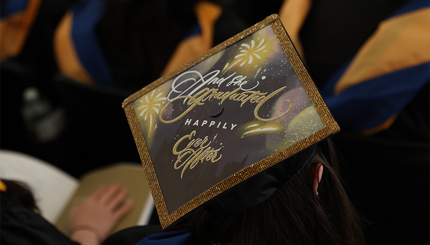 Decorated graduation cap says, "And she graduated happily ever after"
