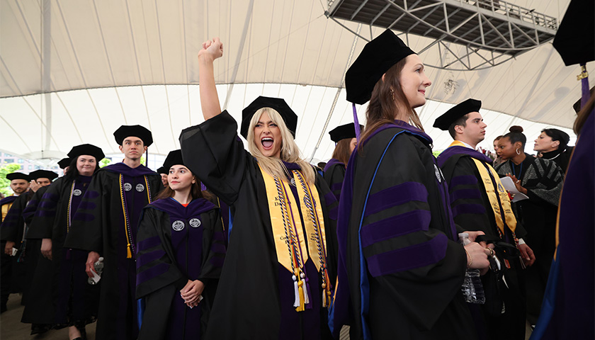 Suffolk Law School students celebrate inside the Leader Bank Pavilion during Commencement 2024