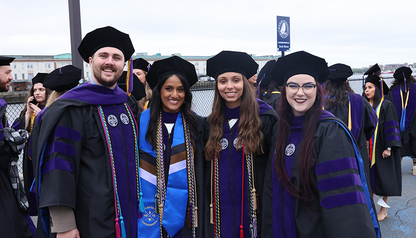 Suffolk Law School students celebrate outside the Leader Bank Pavilion before Commencement 2024