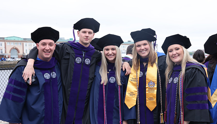 Suffolk Law School students posed outside the Leader Bank Pavilion before Commencement 2024