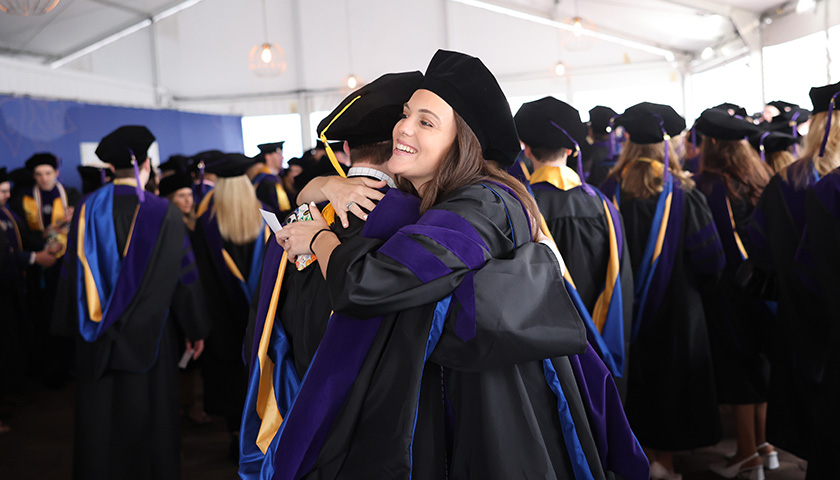 Two Suffolk Law School graduates embraced during Commencement 2024