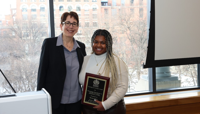 Suffolk President Marisa Kelly presents a 2024 "Creating the Dream" award to Marissa Pierre, assistant director, Student Leadership & Involvement.
